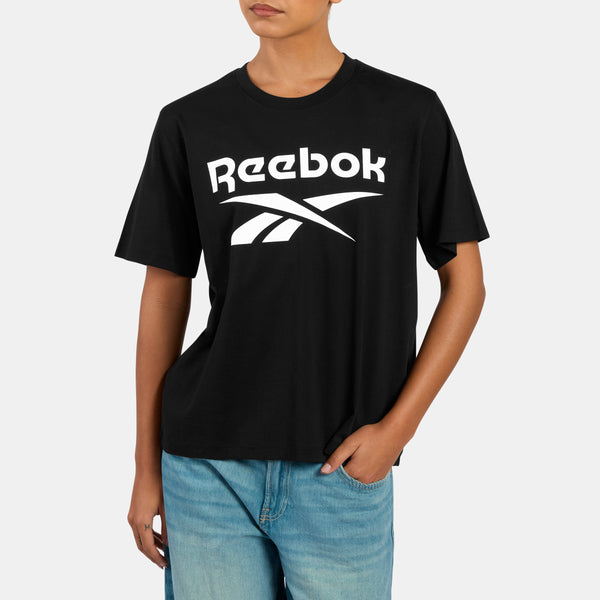 Person wearing a black Reebok t-shirt on a white background