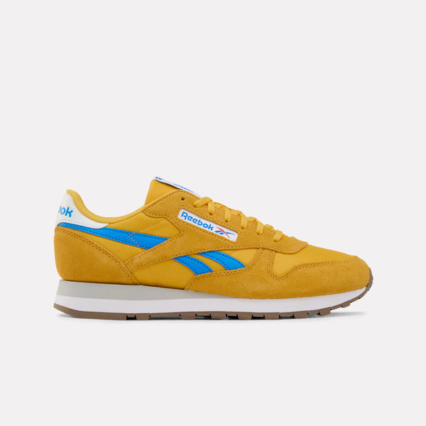 Yellow Reebok Classic Leather Sneaker with blue accents on a white background