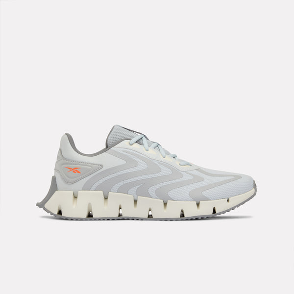 Grey Zig Rise running shoe with white sole on a light grey background