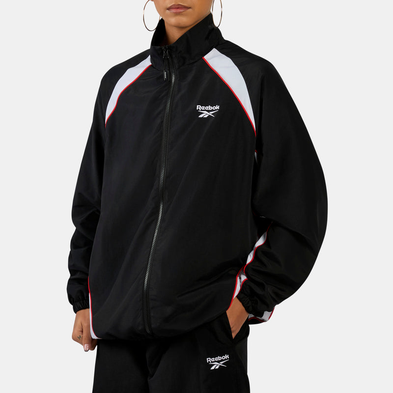 Person wearing a black Reebok Street Sport Track Women's Jacketsuit on a white background