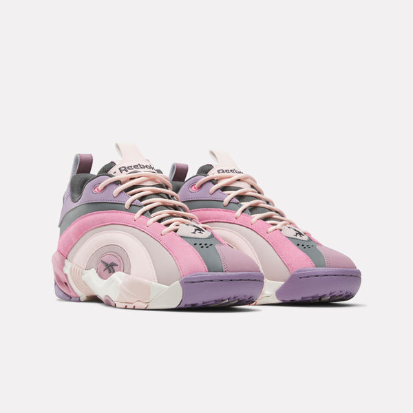 Pair of Reebok Shaqnosis Low Sneakers with pink, gray, and white design on a white background
