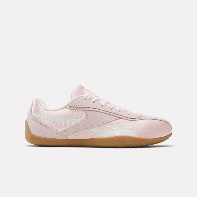 Pink Reebok Ultra Lo Women's Sneaker with a light brown sole on a white background