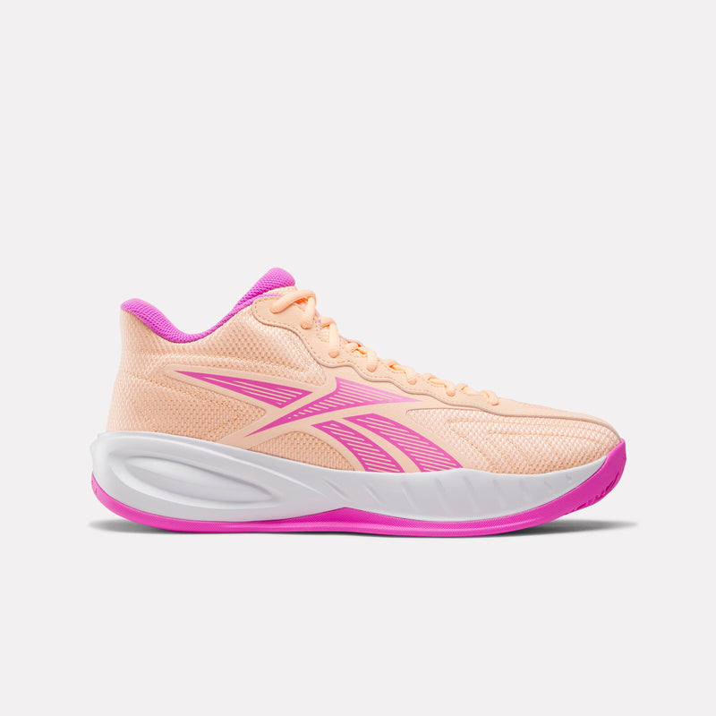 Pink and white Reebok Press Basketball Shoe on a light grey background